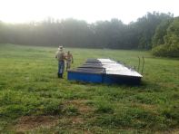 Morning chores, moving the pastured chickens to new grass before the humidity rises!